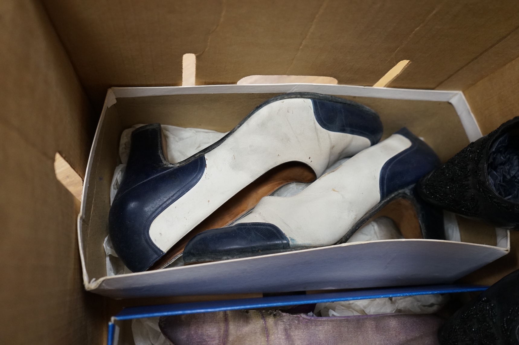 Five pairs of ladies shoes from 1900-1940's; a pair black leather and jet shoes, a pair of cream silk wedding shoes, lilac evening shoes, a pair of two tone leather shoes and a similar navy pair